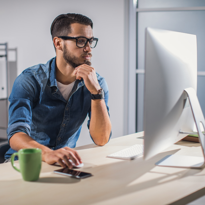 A male administrative assistant updating a schedule